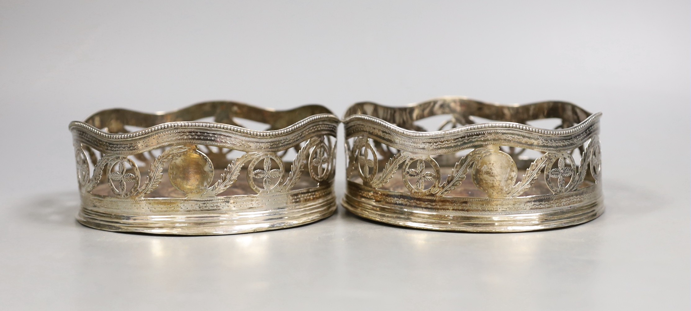 A pair of George III pierced silver wine coasters, maker's mark rubbed, London, 1787,diameter 12.8cm.